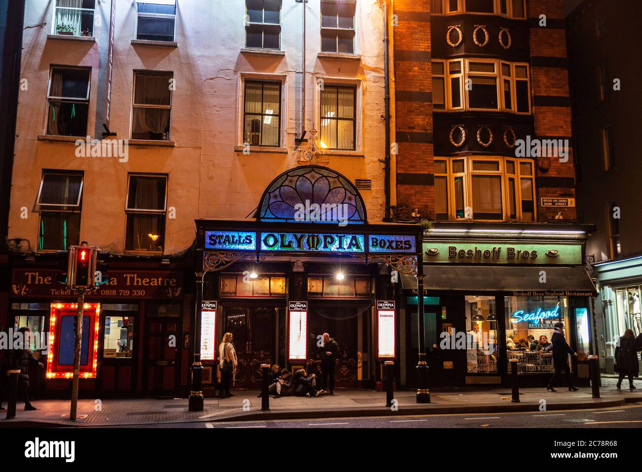 Dublin, Ireland - December 30, 2019: Facade of the Olympia Theatre at night in Dame Street with people around in the center of Dublin, Ireland Stock Photo