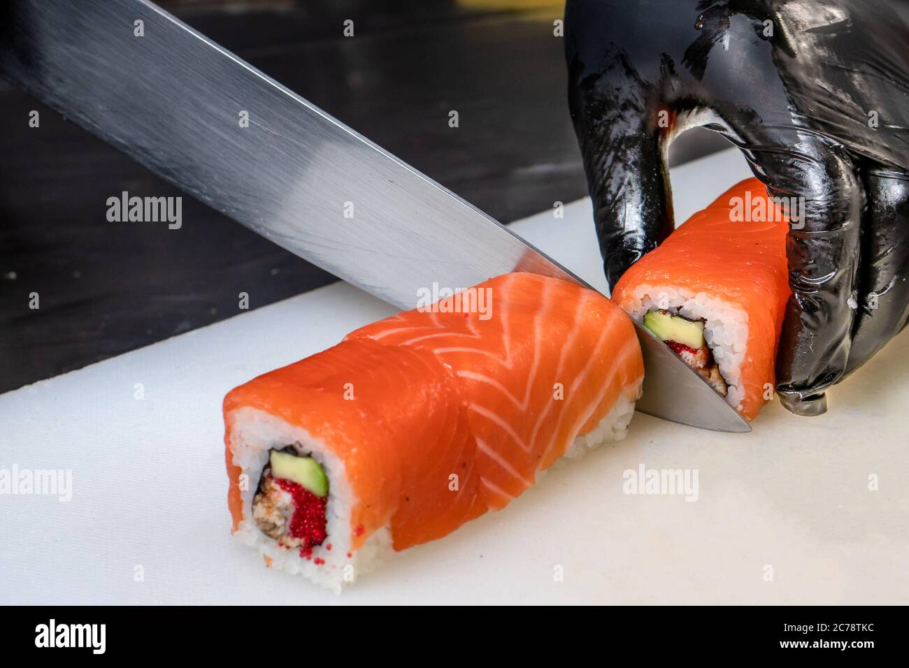 Cut the sushi into pieces. Rolls, cooking. Japanese cuisine Stock Photo