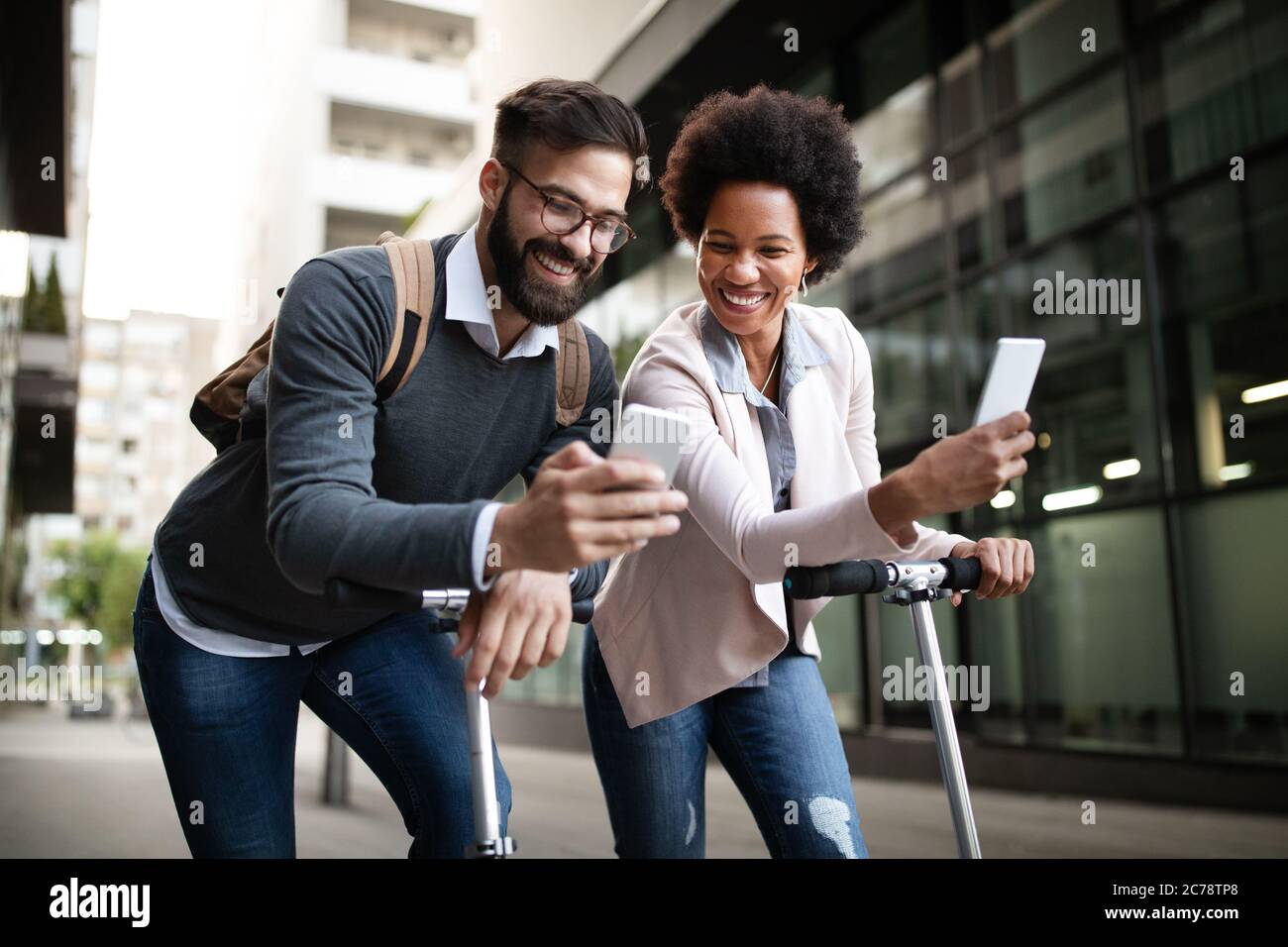 Happy busy people using technology devices outdoor in city Stock Photo