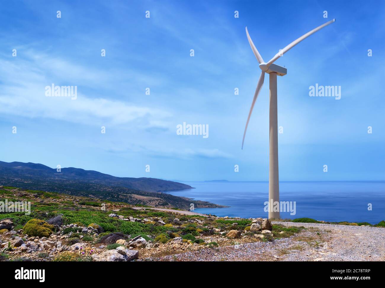 Single windmill turbine on hilltop of seashore in colorful landscape ...