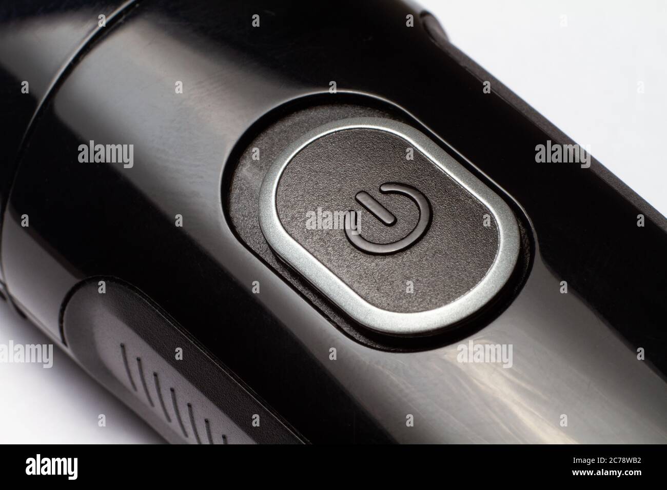 The button is on and off on a black electric razor trimmer on a white ...