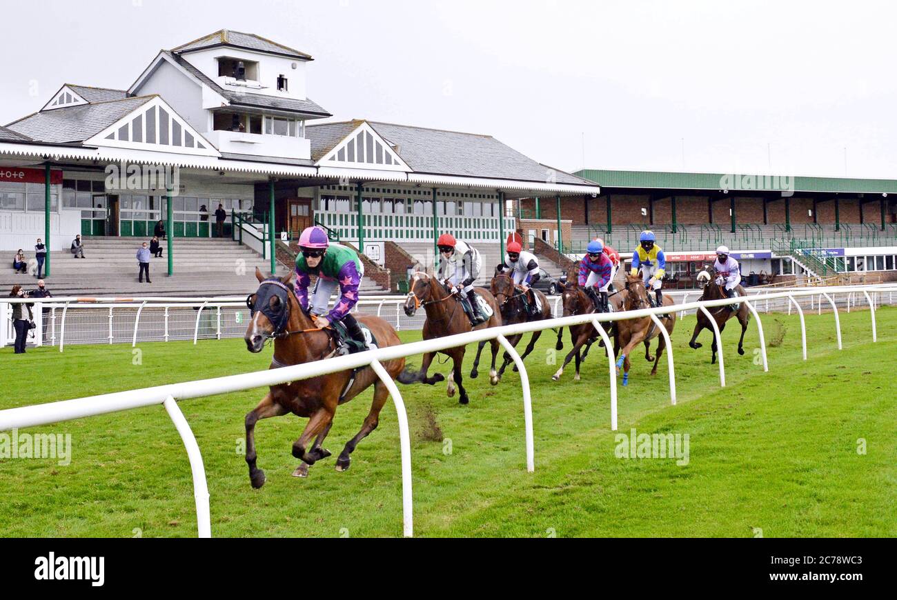 Runners and riders pass the stands as they compete in the Join Racing