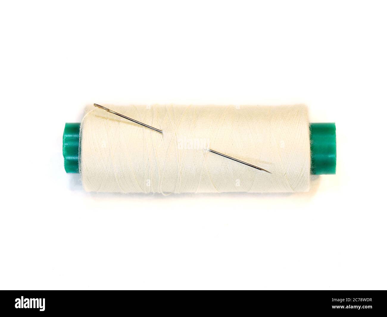 needle and a spool of thread. Isolated on white Stock Photo - Alamy
