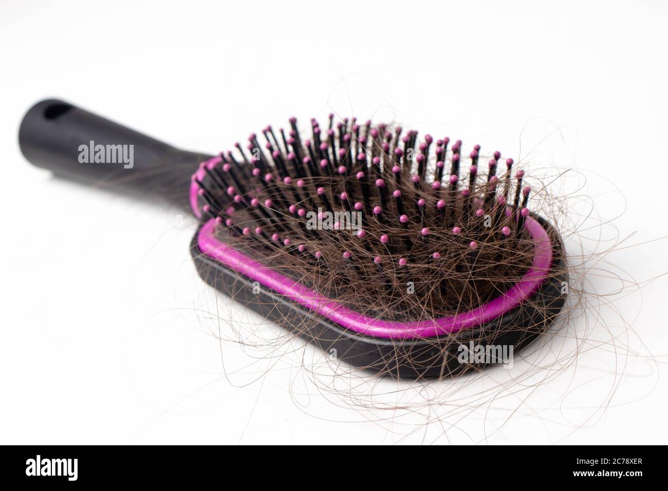 Hair loss on a comb on a white background. Baldness. Stock Photo