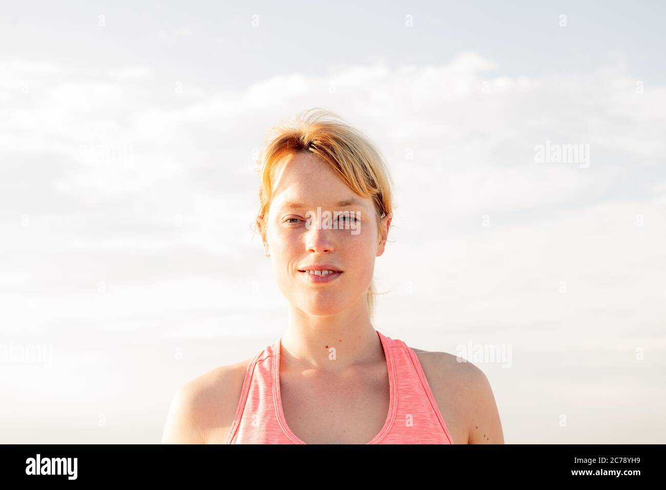 portrait of a beautiful blonde woman with the sky in the background, concept of mental health care and relaxation, copy space for text Stock Photo