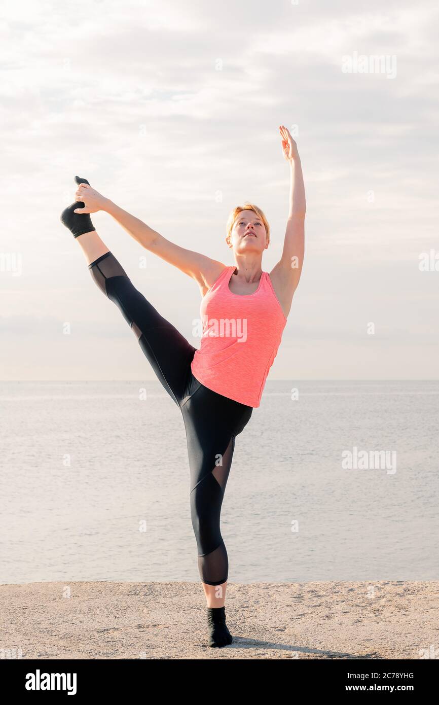 Calm blonde stretching legs hi-res stock photography and images - Alamy