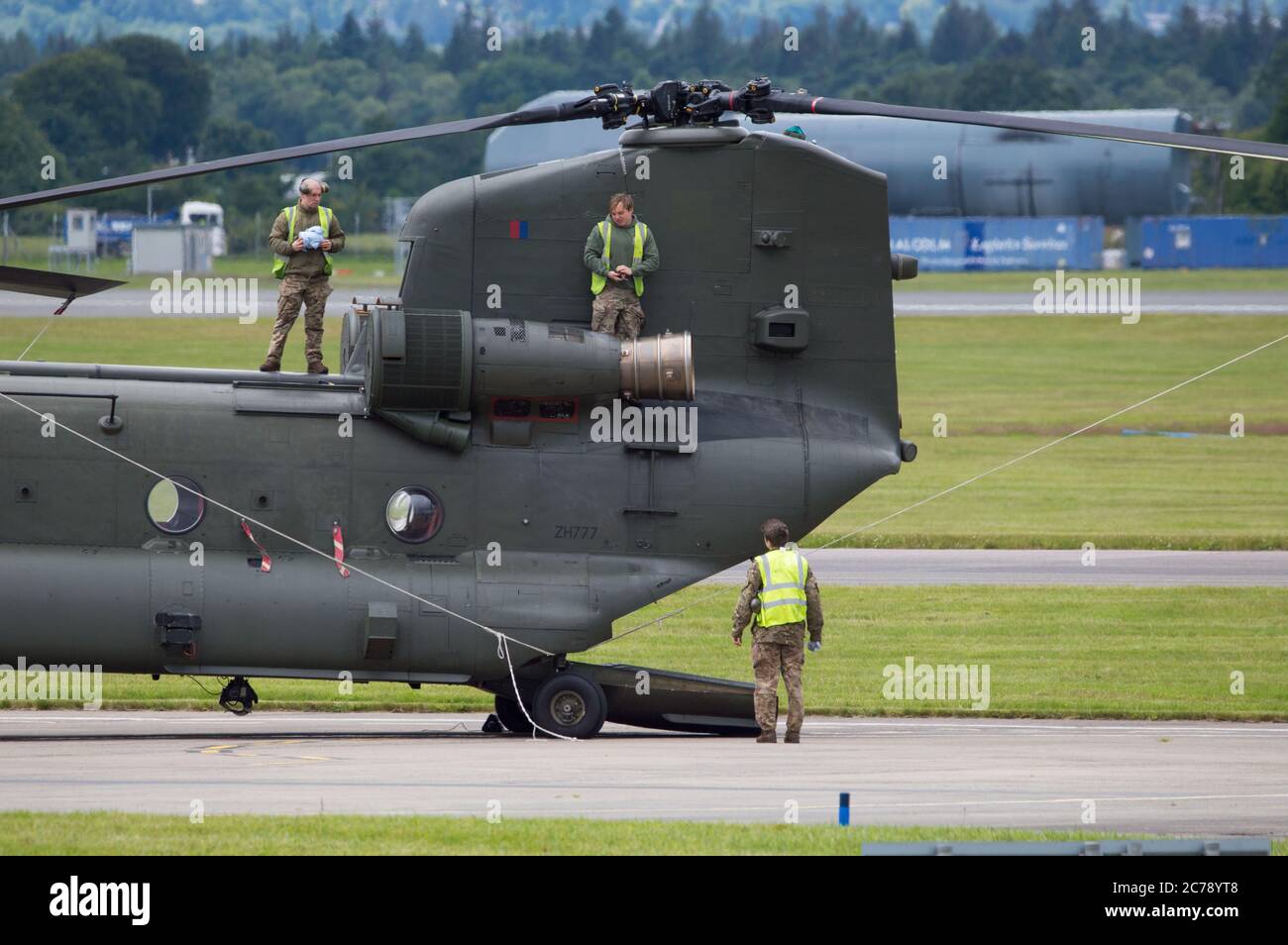 Glasgow, Scotland, UK.15 July 2020. Pictured: Royal Air Force Chinook Helicopters seen on the tarmac at Glasgow International Airport. One of the helicopters have gone ‘tech’ and a spare part has been flown in. Credit: Colin Fisher/Alamy Live News Stock Photo