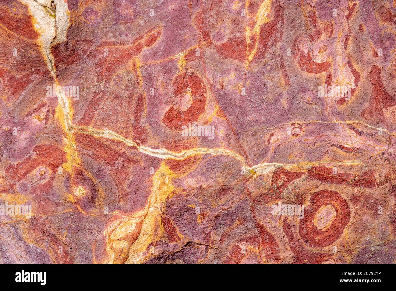 Colorful sand and sedimentary rocks, creating abstract patterns on the ...