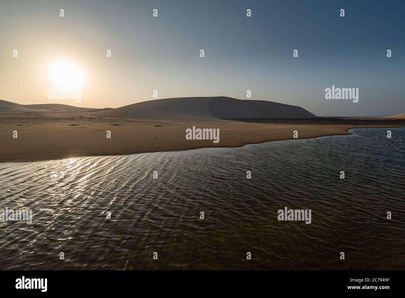 Sun rising in the dunes and lagoons near Tatajuba beach, Camocim, Ceara, Brazil Stock Photo