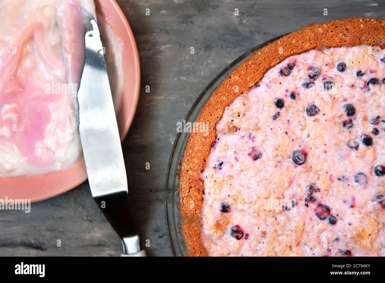 Preparing to grease a sponge cake with yogurt cream Stock Photo Alamy