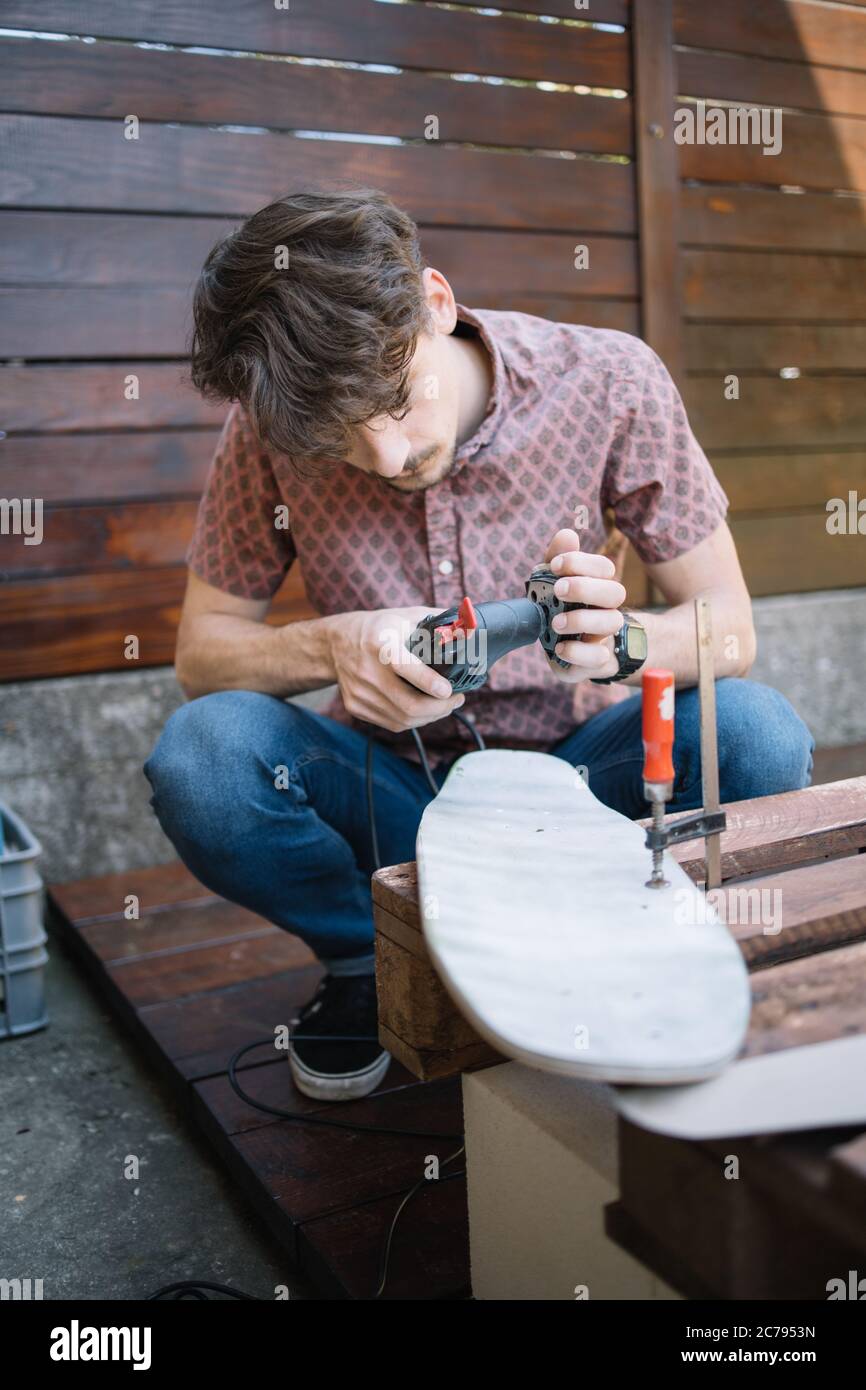 Man putting sanding sheet to power sander Stock Photo Alamy