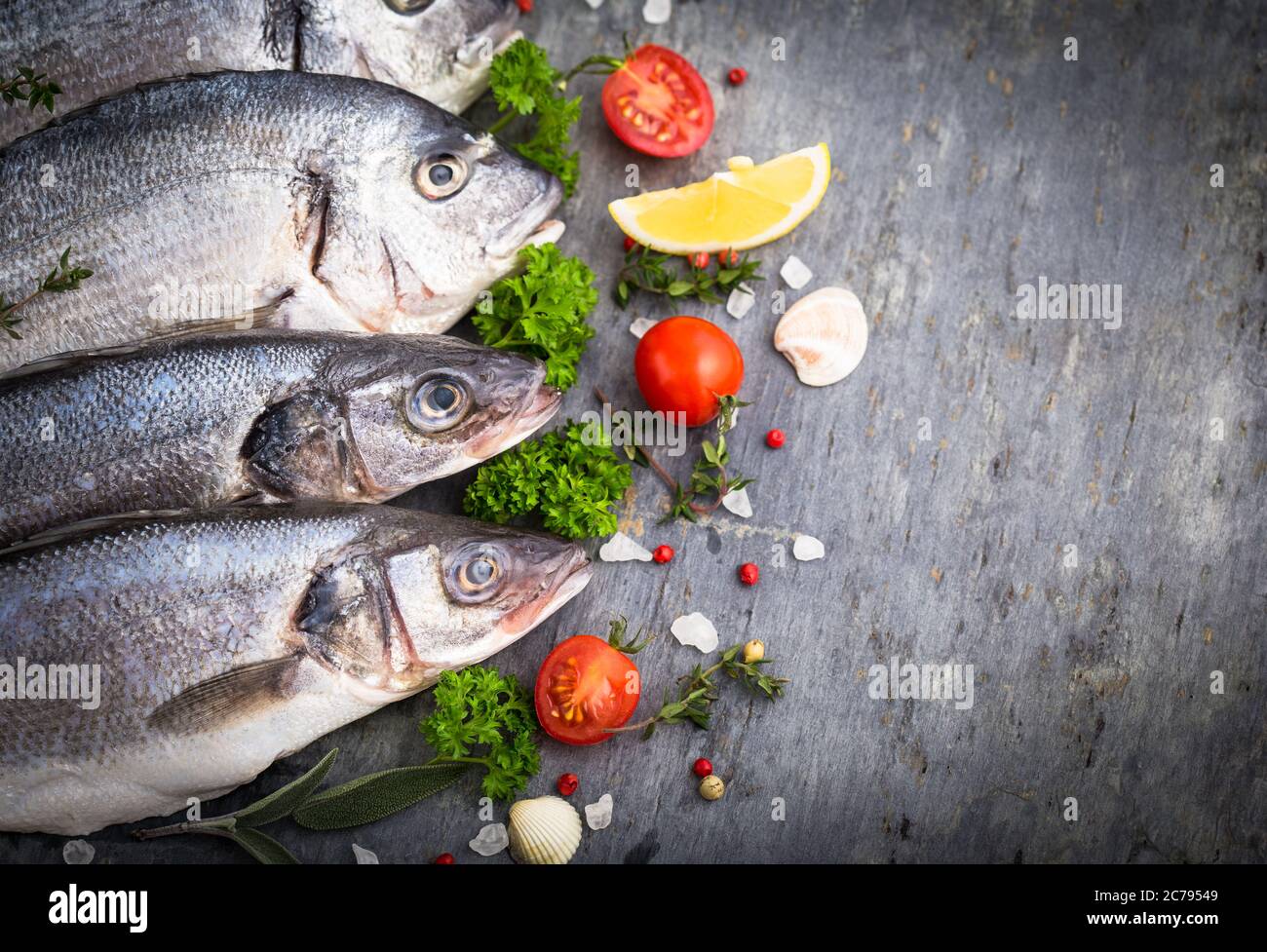 Fresh raw fish on the stone table Stock Photo - Alamy
