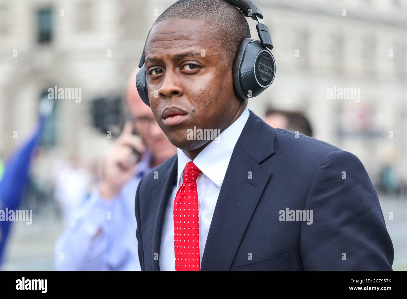 Westminster, London, UK. 15th July, 2020. Conservative MP Bim Afolami walks through the crowd but does not interact. Pro European Anti Brexit protesters and campaigners around Steve (Steven) Bay hold their weekly protest outside the gates at the Houses of Parliament and in Parliament Square, Westminster as MP's hold PMQs inside the House of Commons. Credit: Imageplotter/Alamy Live News Stock Photo