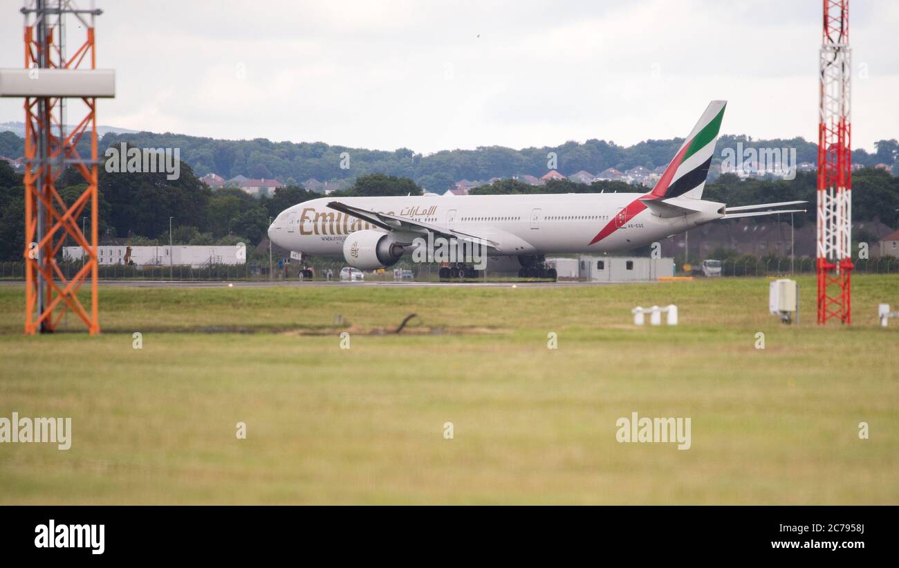 Glasgow, Scotland, UK. 15th July, 2020. Pictured: Emirates flight EK28, Boeing 777-31H(ER) aircraft (reg A6-EGE) departs Glasgow International Airport for Dubai. First flight back after the lockdown was eased. Following the coronavirus (COVID19) crisis, the global aviation industry has been massively affected, causing some airlines to go bust and the others to cut huge numbers of staff and cancel orders on new aircraft. Emirates cancelled their flights to Glasgow until today. Credit: Colin Fisher/Alamy Live News Stock Photo