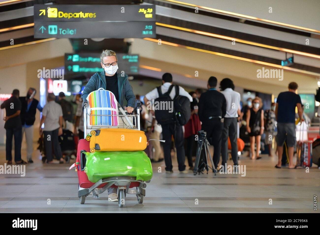 Male. 15th July, 2020. A passenger pushes a luggage cart after getting off the first flight into the country in months at the Velana International Airport in Male, the Maldives, July 15, 2020. A Qatar Airways flight carrying 107 foreigners and 27 Maldivians arrived at the Velana International Airport in the Maldives on Wednesday morning, marking the first arrival of tourists since the country closed its borders on March 27 amid the COVID-19 pandemic. Credit: Xinhua/Alamy Live News Stock Photo
