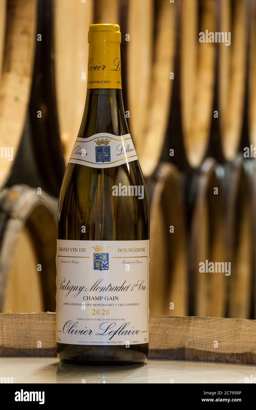 PULIGNY-MONTRACHET 2020 OLIVIER LEFLAIVE Premier cru ‘Champ Gain’ wine bottle on barrel in wine tasting barrel cellar Burgundy Cote d’Or France Stock Photo