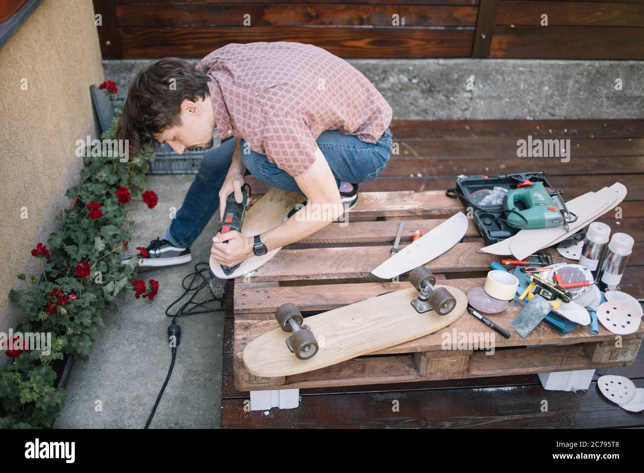 Sanding and polishing wooden deck for skateboard Stock Photo Alamy