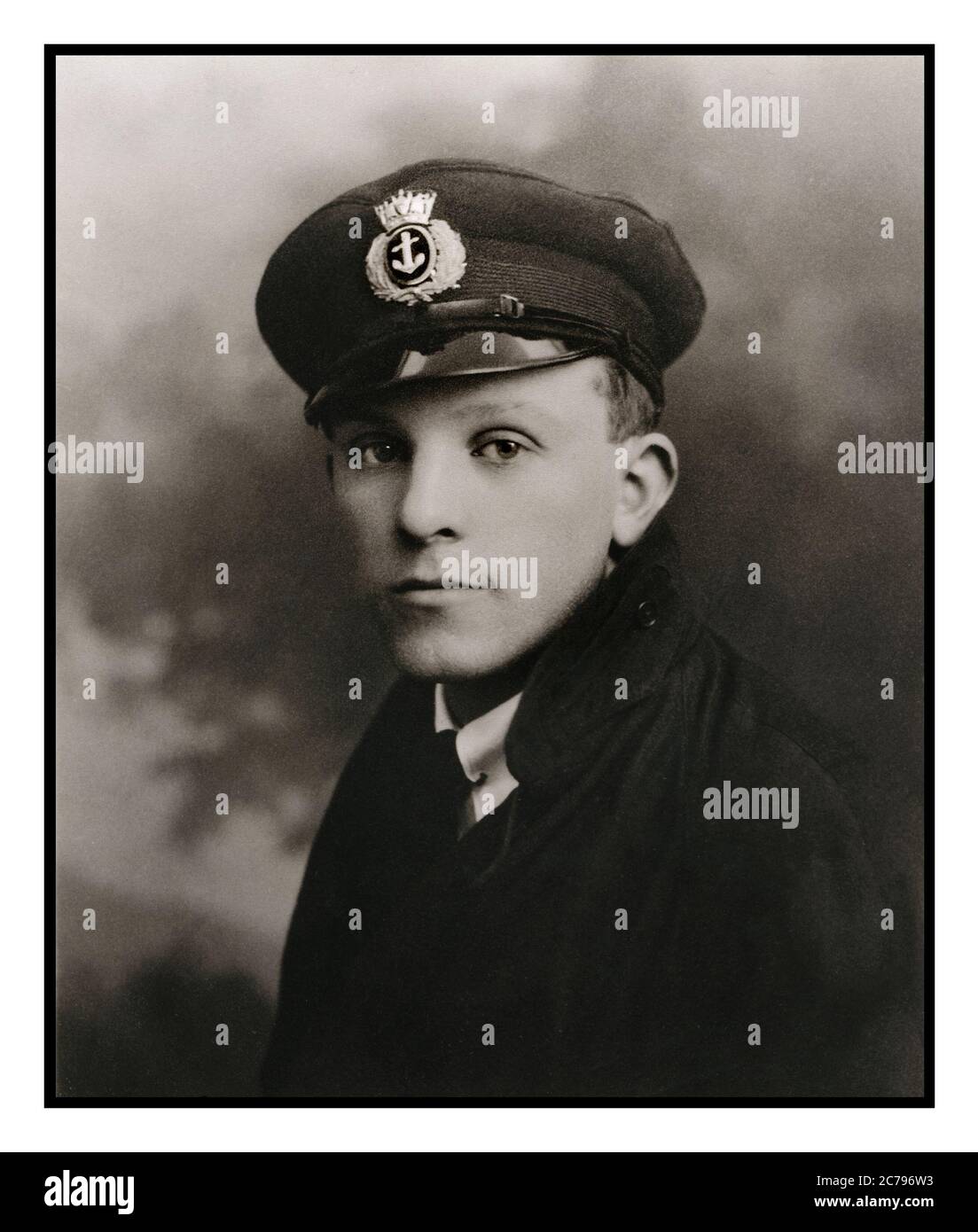 Merchant Navy Seaman in Uniform Archive studio portrait of 18-20 years British merchant seaman 1920's in uniform with cap badge displaying the crest of the UK Merchant Navy service Stock Photo