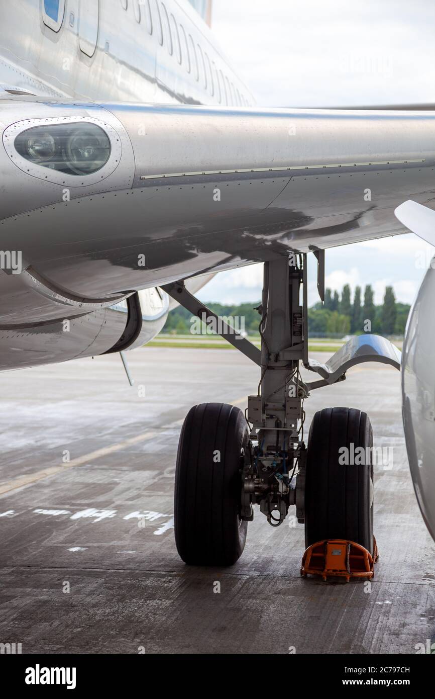 Chassis wheel under the wing of a white passenger plane. Parking at the