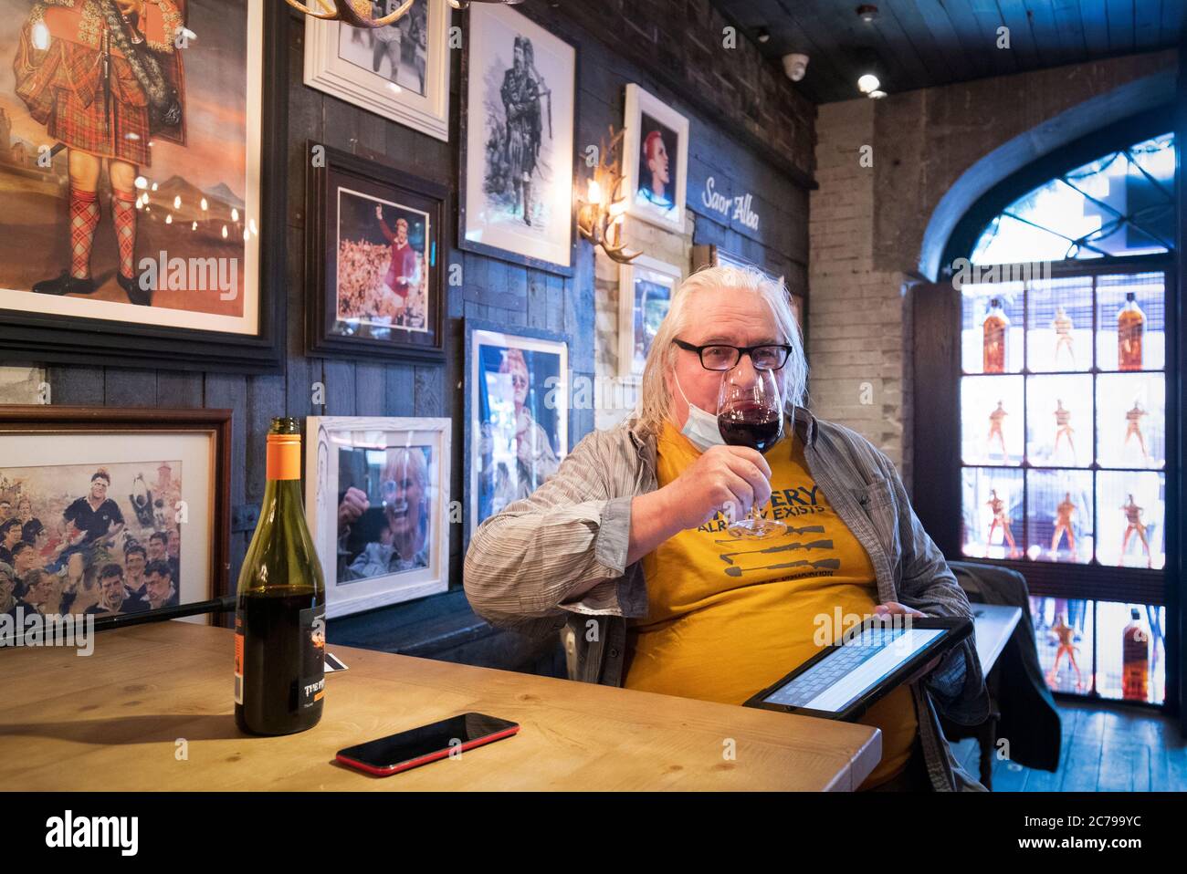 Bill Day, aged 70, one of the first customers to be served at The Piper's Rest pub in Edinburgh as pubs, bars and restaurants across Scotland have opened indoor areas for the first time since March after the lifting of further coronavirus lockdown restrictions. Stock Photo