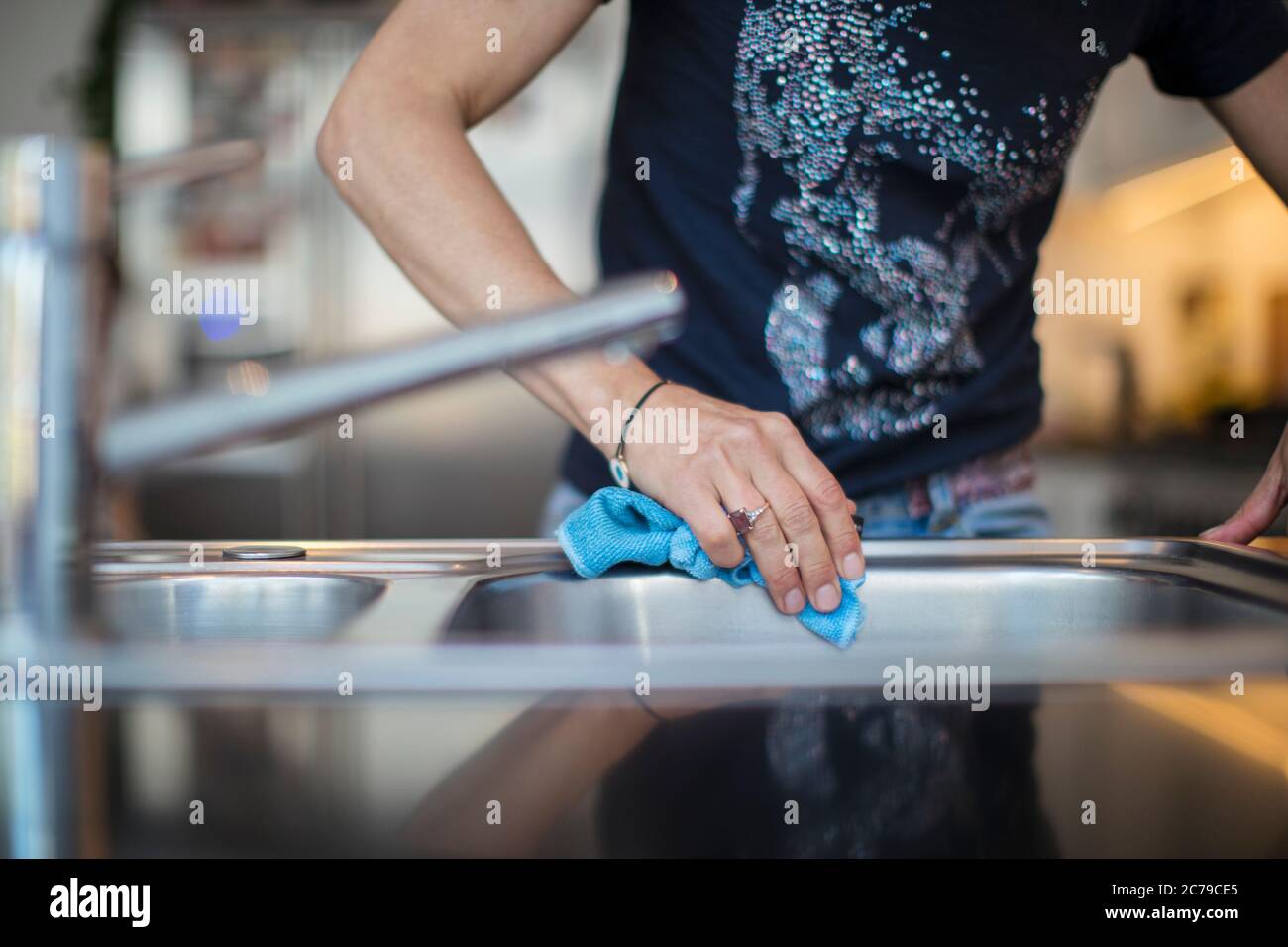 Close up woman disinfecting sink Stock Photo