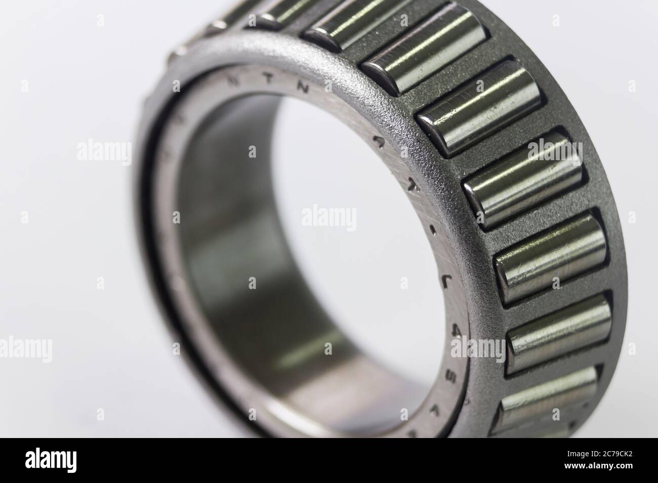 Close up of the inner race of a taper roller bearing, made by NTN Corporation of Japan. The bearing is a used item, removed from a 1993 folding camper Stock Photo