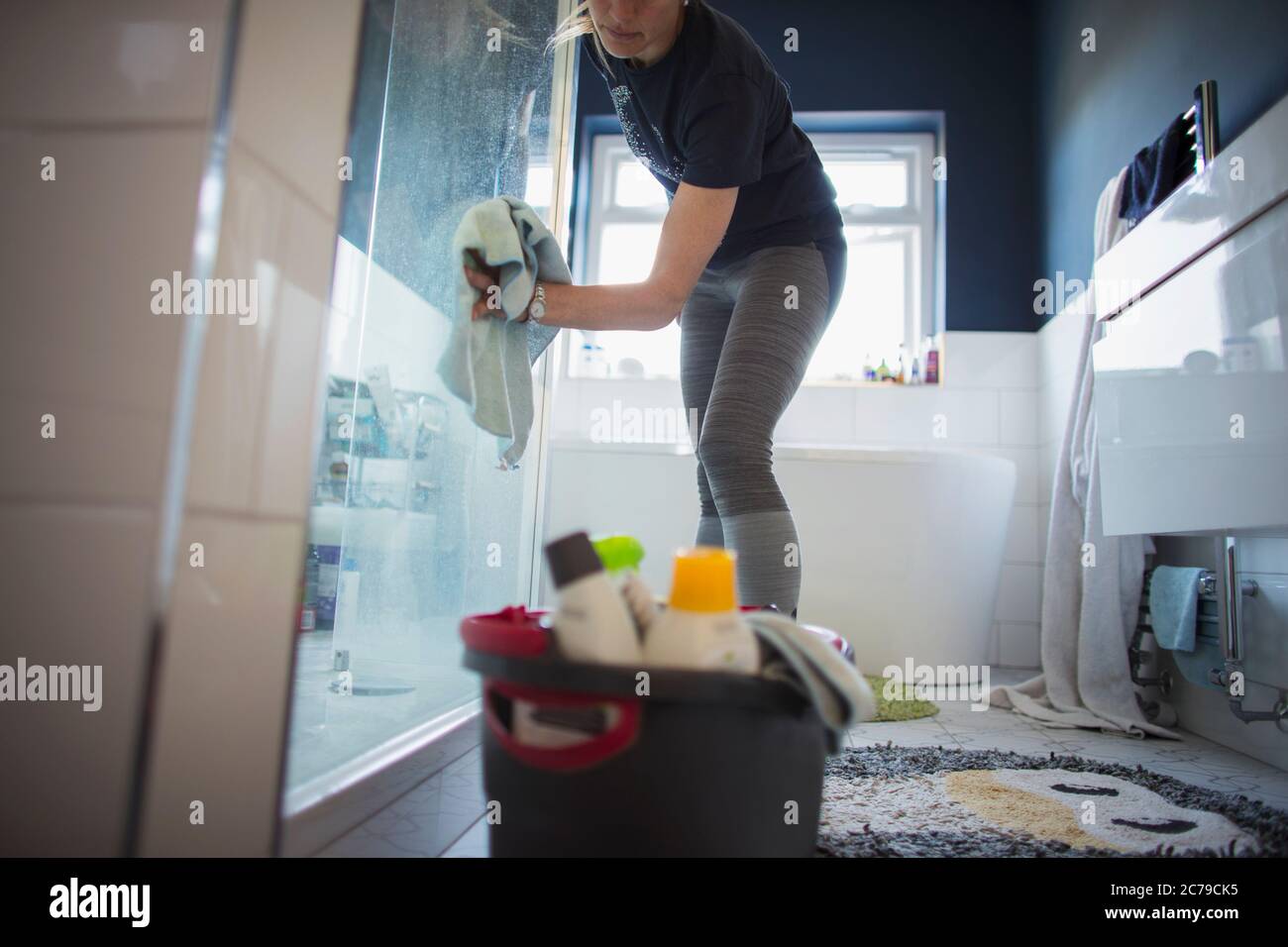 Woman cleaning bathroom Stock Photo