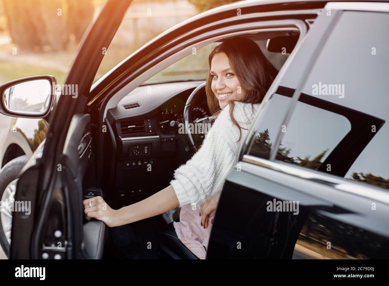Pretty young woman sitting in the car Stock Photo - Alamy