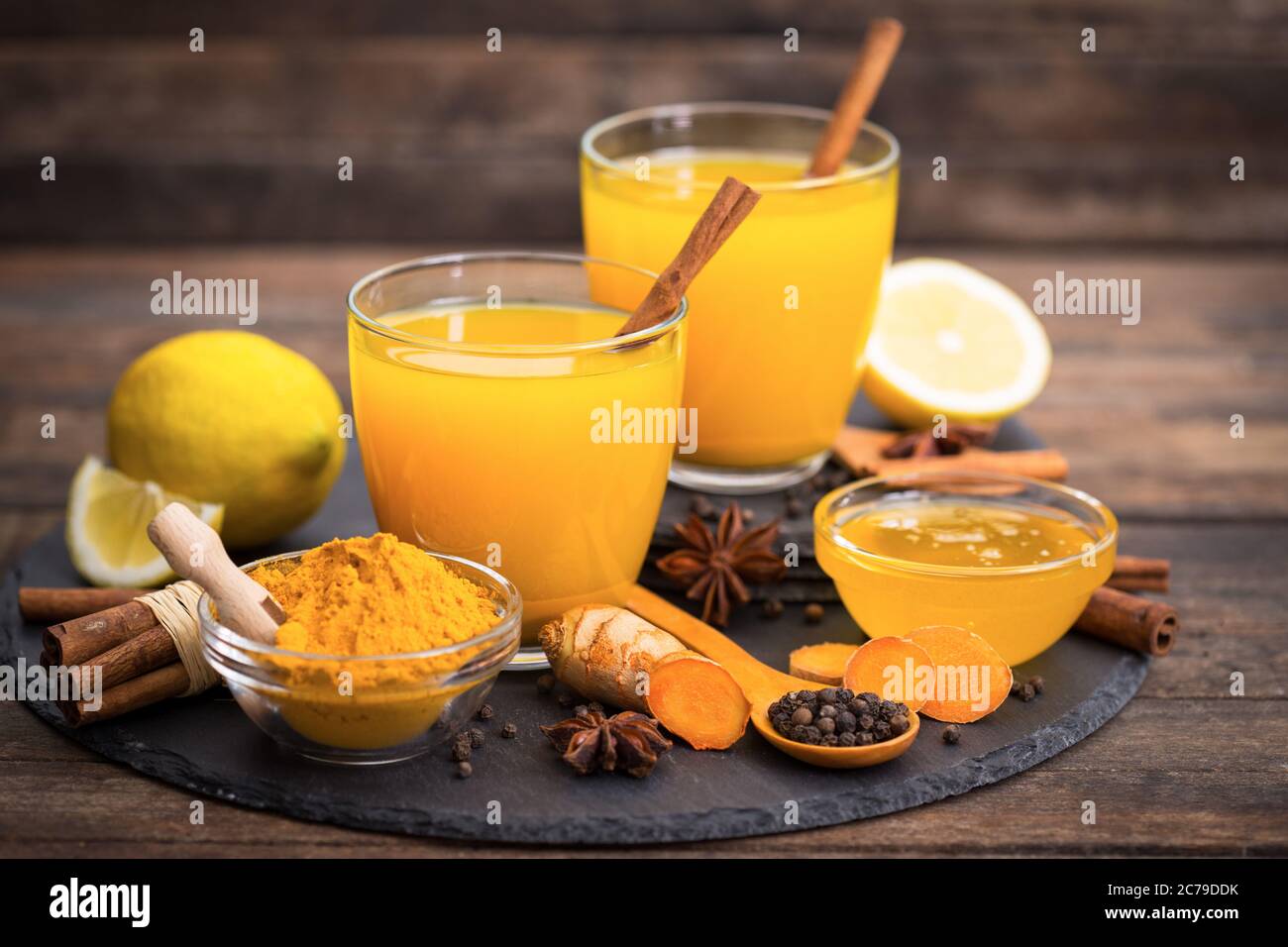 Healthy turmeric drink with honey, cinnamon, lemon and ginger Stock