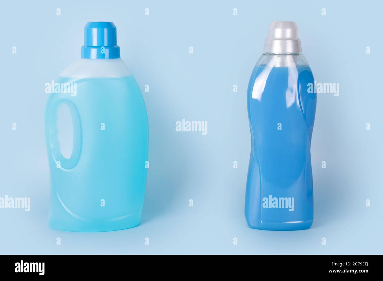 Bottles of detergent and fabric softener on blue background. Containers