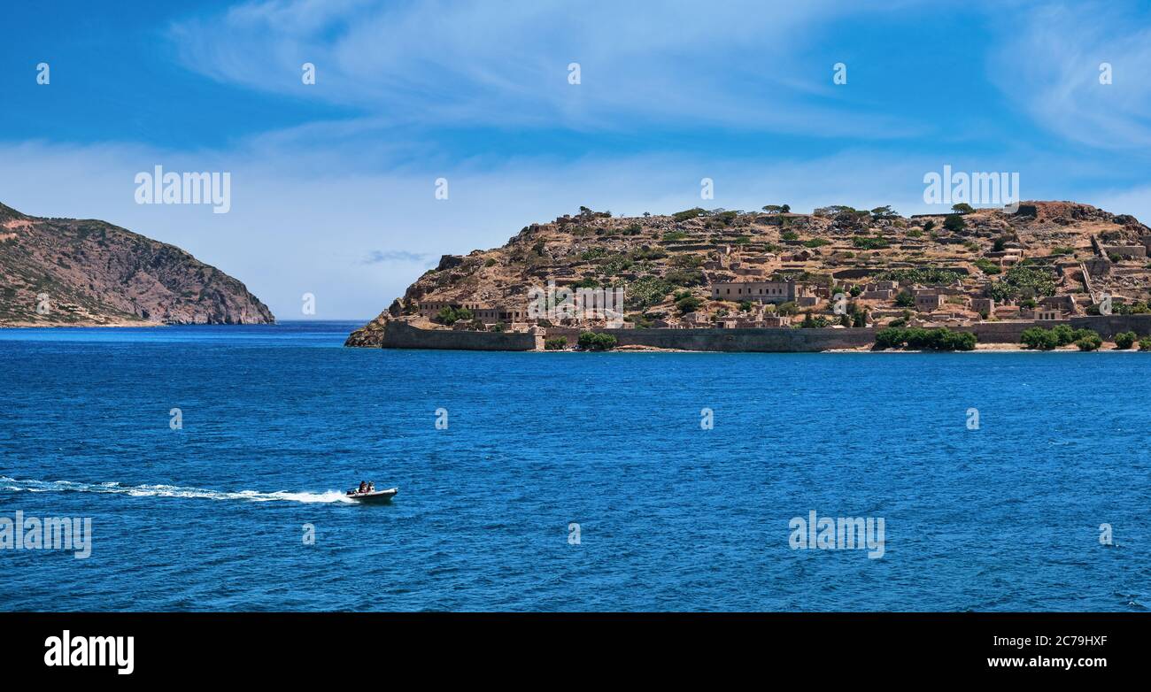 View of west bank of Spinalonga island and Venetian fortress on clear sunny summer day, Crete, Greece Stock Photo