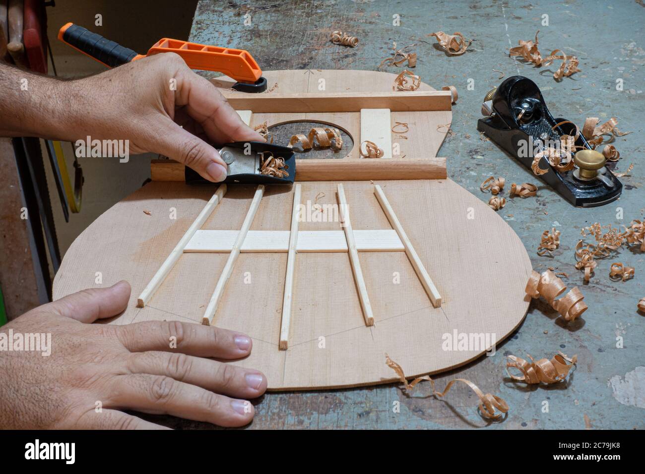 Luthier workbench with tools and a top of an acoustic guitar under  construction Stock Photo - Alamy