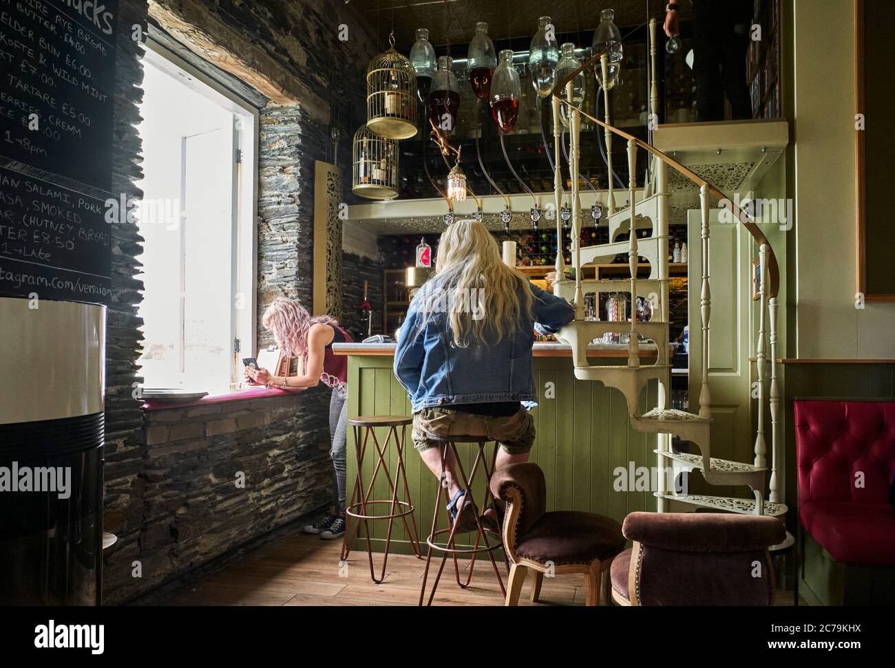 Interior of Foraging Vintners bar in Port Erin interior with man with long hair sitting at the bar Stock Photo