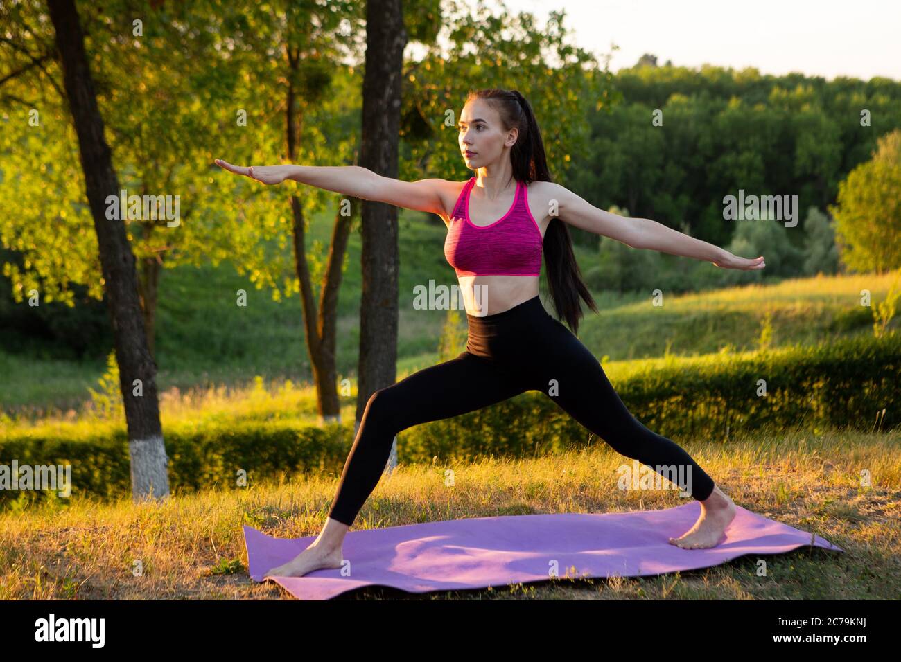 Woman doing exercise to keep fit in the park Stock Photo