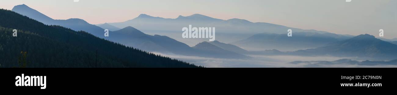 Bizkaia mountains at sunrise with Gorbea in the background and fog in the valleys Stock Photo
