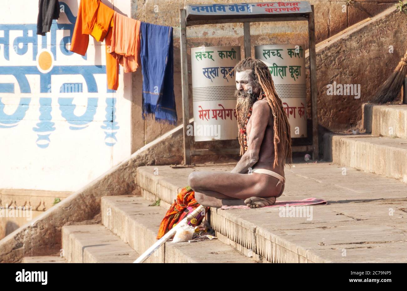 A Naga Sadhu sits in front of his tent at the Varanasi ghats Stock Photo