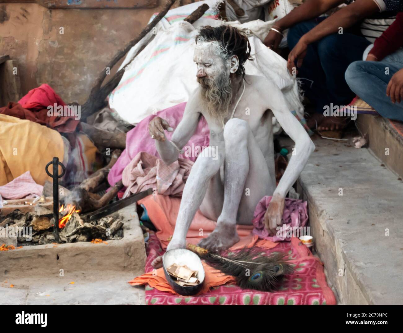 A Naga Sadhu sits in front of his tent at the Varanasi ghats Stock Photo