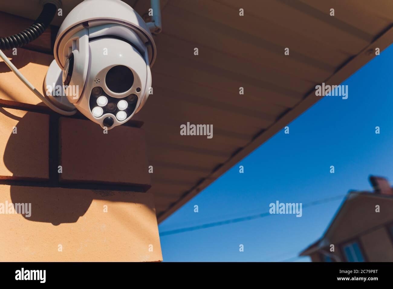 technician female setup cctv camera on wall. Stock Photo