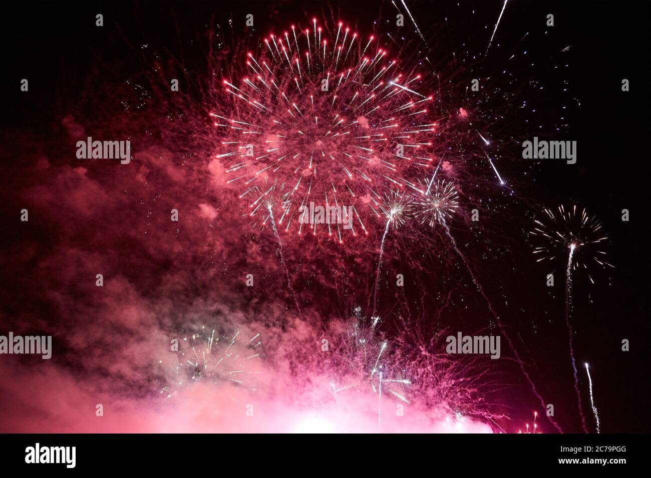 Bright colorful fireworks in the dark night sky Stock Photo