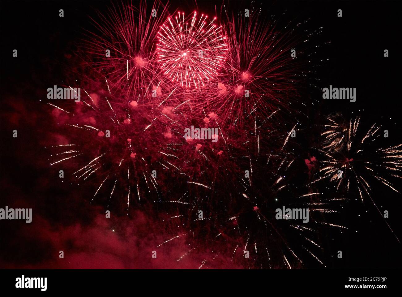 Bright colorful fireworks in the dark night sky Stock Photo