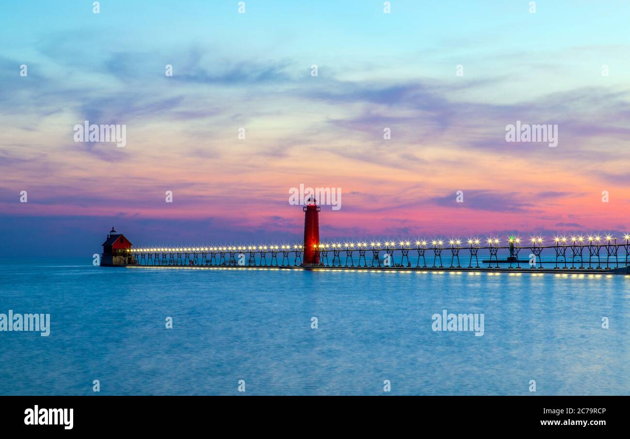 View of the Grand Haven South Pierhead Inner and Outer Lighthouses at sunset; Grand Haven State Park, Lake Michigan Stock Photo