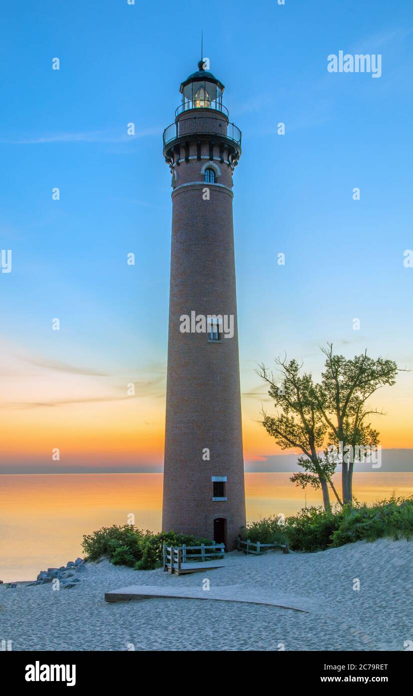 View of Little Sable Point Lighthouse at sunset overlooking Lake Michigan; Silver Lake State Park, near Mears, Michigan Stock Photo