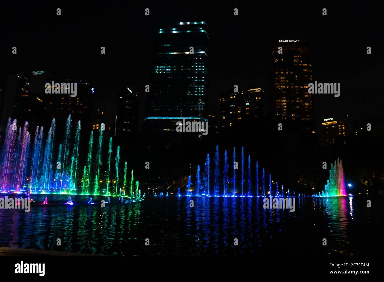 Night view of the dancing multi-colored fountains. Show of Singing Fountains. Stock Photo