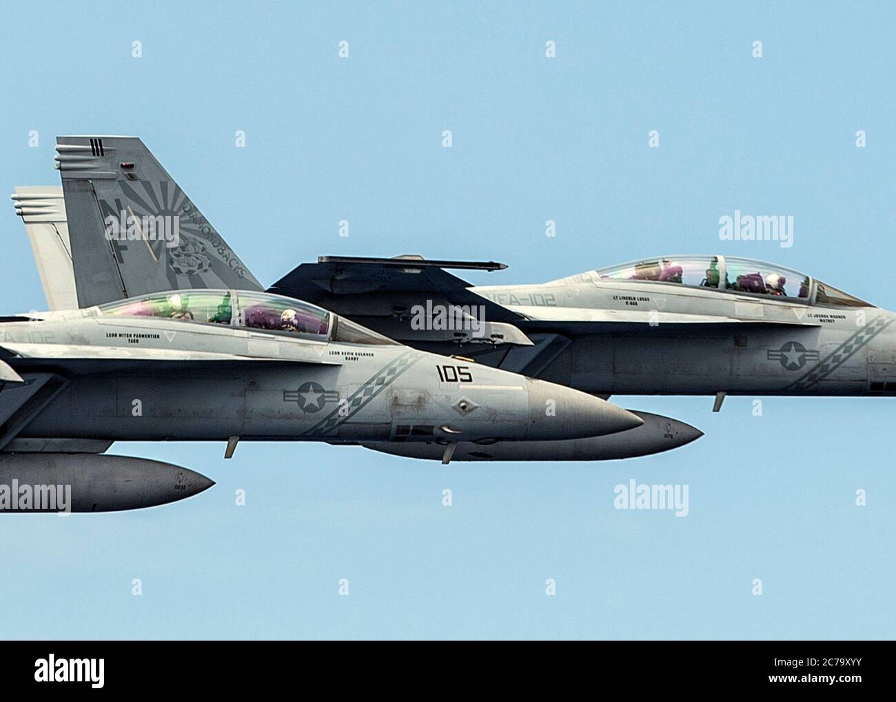 Two U.S. Navy F/A-18F Super Hornet fighter aircraft, from the Diamondbacks of Strike Fighter Squadron 102, fly in formation off the aircraft carrier USS Ronald Reagan May 30, 2020 in the Philippine Sea. Commander, of the U.S. 7th Fleet, Vice Adm. Bill Merz hitched a ride in the back seat of the aircraft during a visit to the ship. Stock Photo
