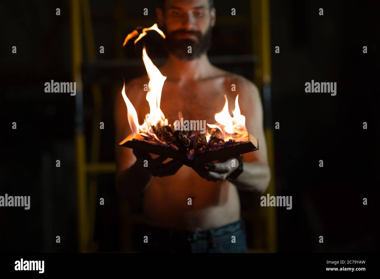 Man hold burning book in his hands Stock Photo