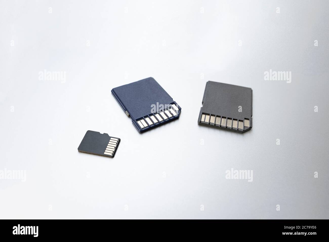 Three micro SD memory cards on gray background, selective focus. concept of memory, information storage, data storage Stock Photo