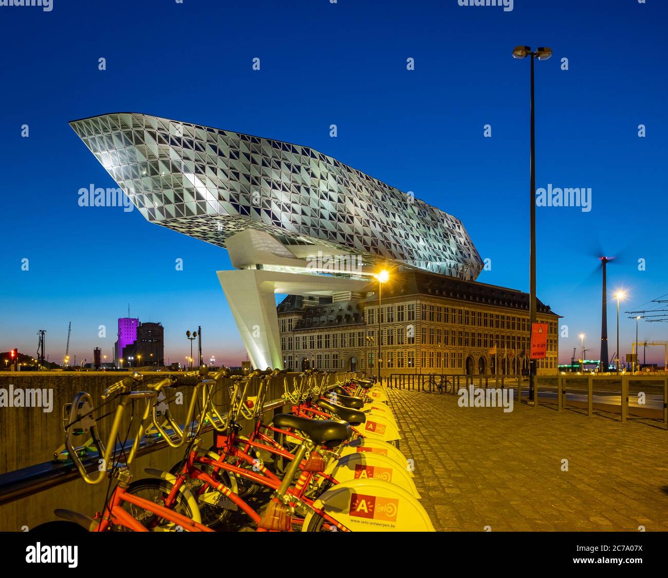 Antwerp Port House at night with a line of Antwerp City bikes Stock Photo