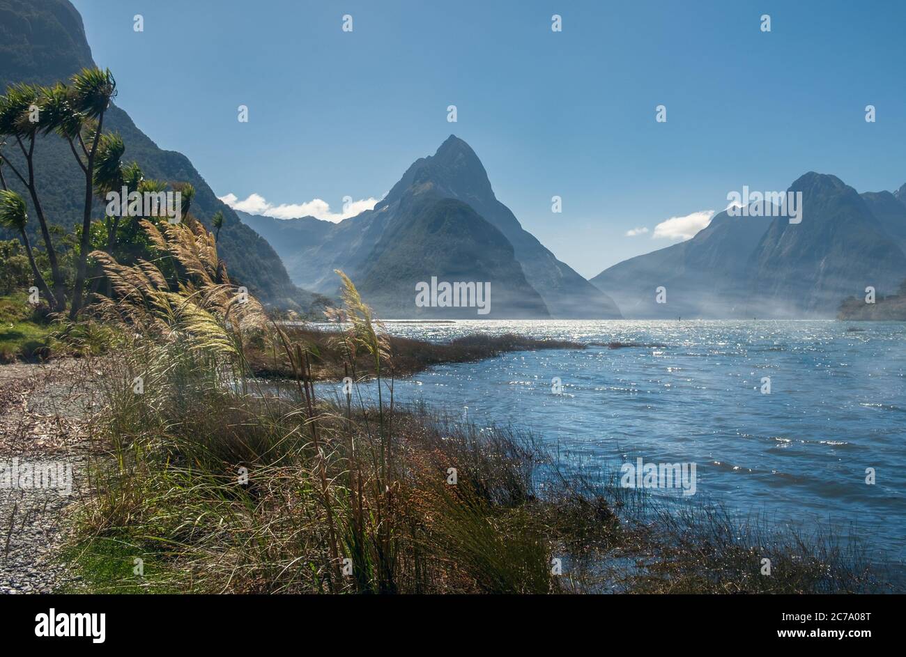 Mitre Peak towering above the morning fog in Milford Sound, New Zealand. Stock Photo