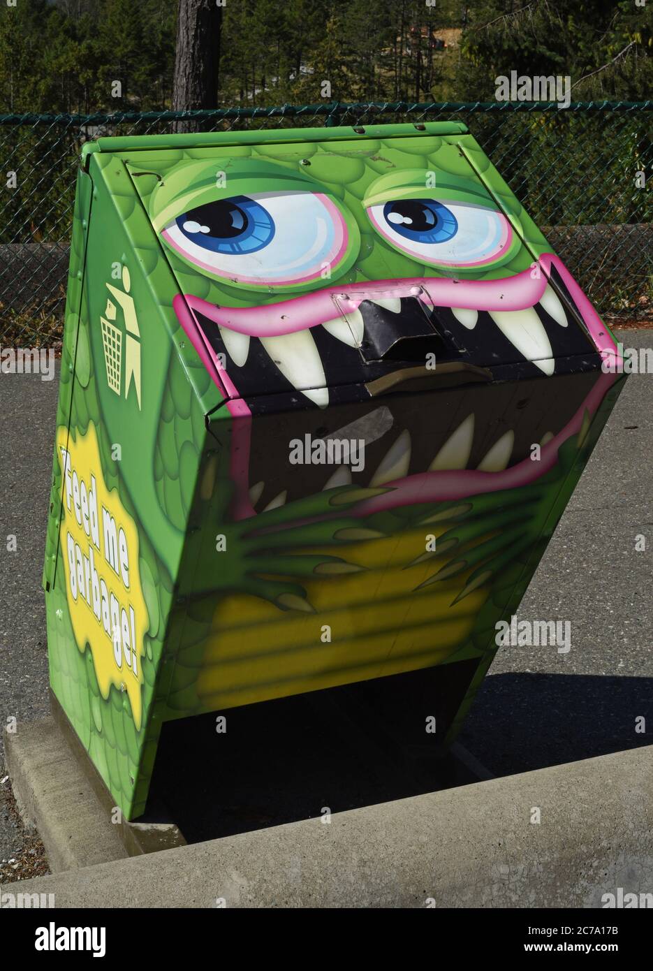A garbage can painted to look like a cartoon type monster located at a highway rest stop on Vancouver Island, British Columbia, Canada. On the side it Stock Photo