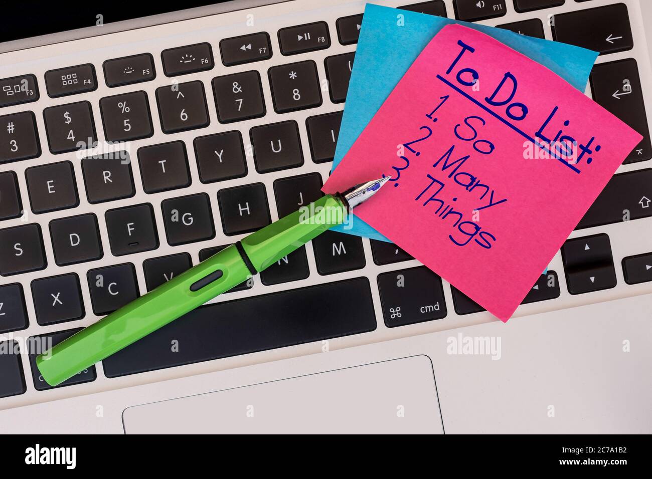 Note on keyboard with 'so many things' on to do list. Stock Photo